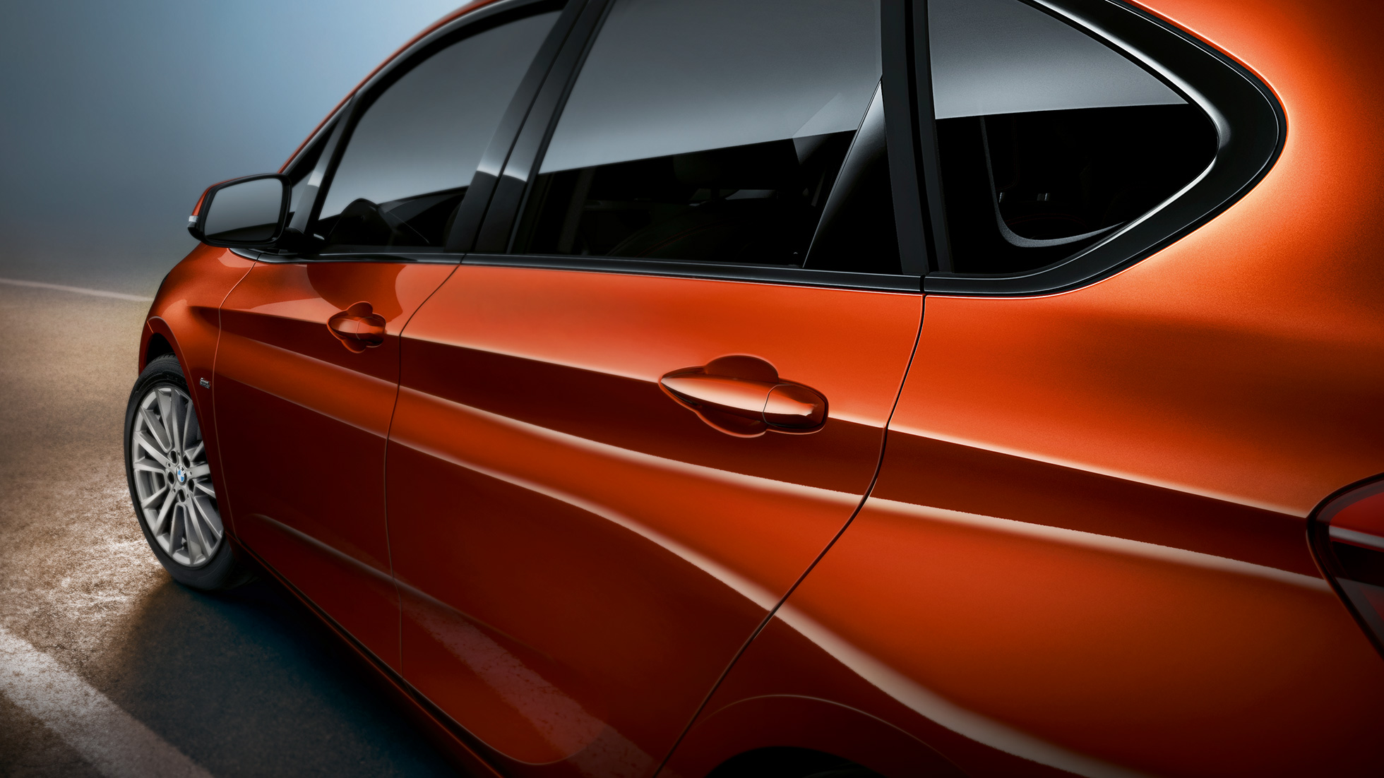Close-up zijkant BMW 2 Serie Active Tourer BMW 2 Serie Active Tourer F45 Facelift Sunset Orange metallic close-up zijkant