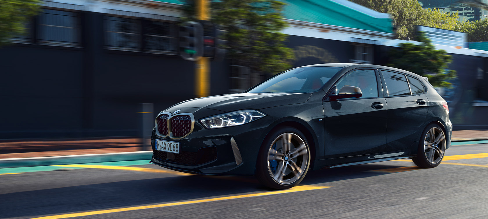 BMW M135i xDrive (F40) in Saphirschwarz metallic, rijdend in stad
