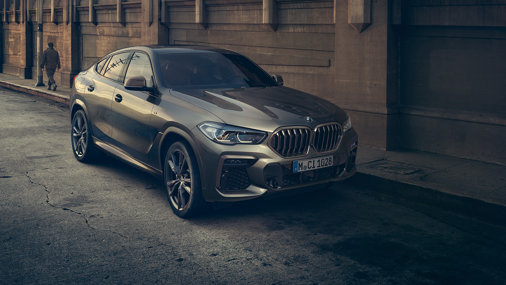 BMW X6 M50i stilstaand BMW X6 M50i driekwart vooraanzicht stilstaand in stad