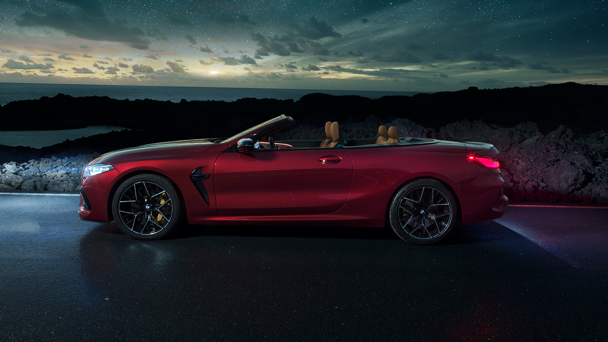 BMW M8 Competition Cabrio, zijaanzicht. BMW M8 Competition Cabrio in Motegi Rot metallic, open dak, zijaanzicht