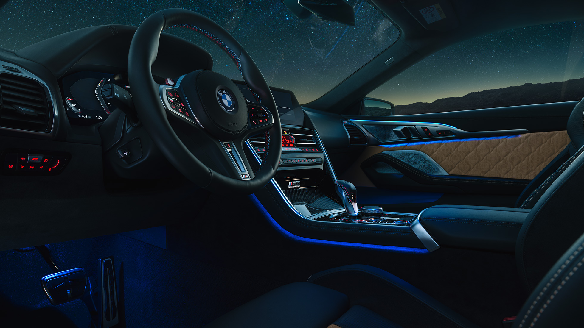 BMW M8 Competition Coupé, cockpit. BMW M8 Competition Coupé, cockpit met M stuurwiel met leder bekleed en blauwe ambianceverlichting.