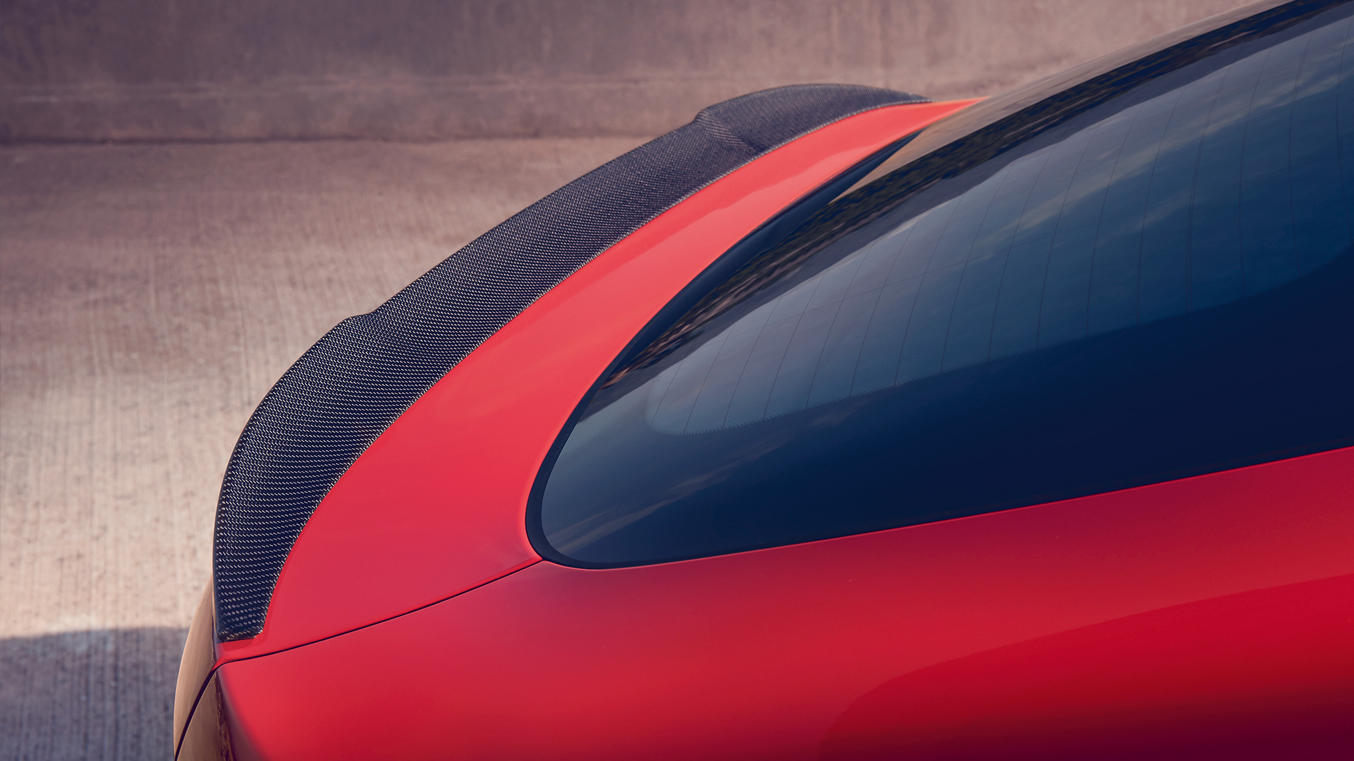 BMW X4 M Competition, M achterspoiler in Carbon. BMW X4 M Competition in Toronto Red metallic, exterieur, M Carbon exterieurpakket, achteraanzicht met M achterspoiler in Carbon.