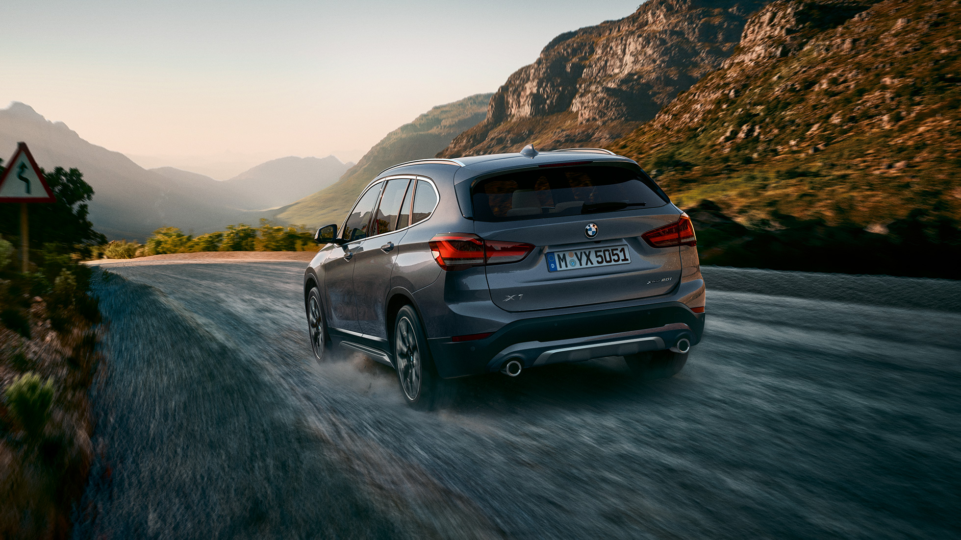 BMW X1, driekwart achteraanzicht. BMW X1, driekwart achteraanzicht rijdend.