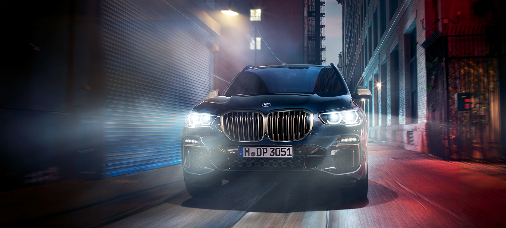 BMW X5 M50d in actie De BMW X5 M50d op een weg 's nachts in de stad