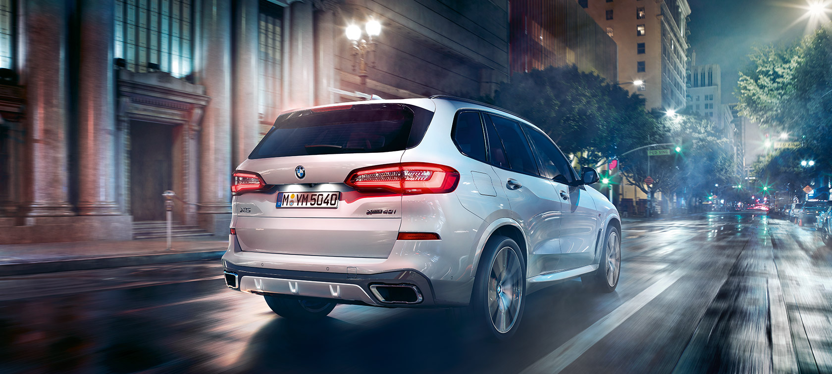 BMW X5 driekwart achteraanzicht rijdend BMW X5 G05 2018 Mineralweiß metallic driekwart achteraanzicht rijdend