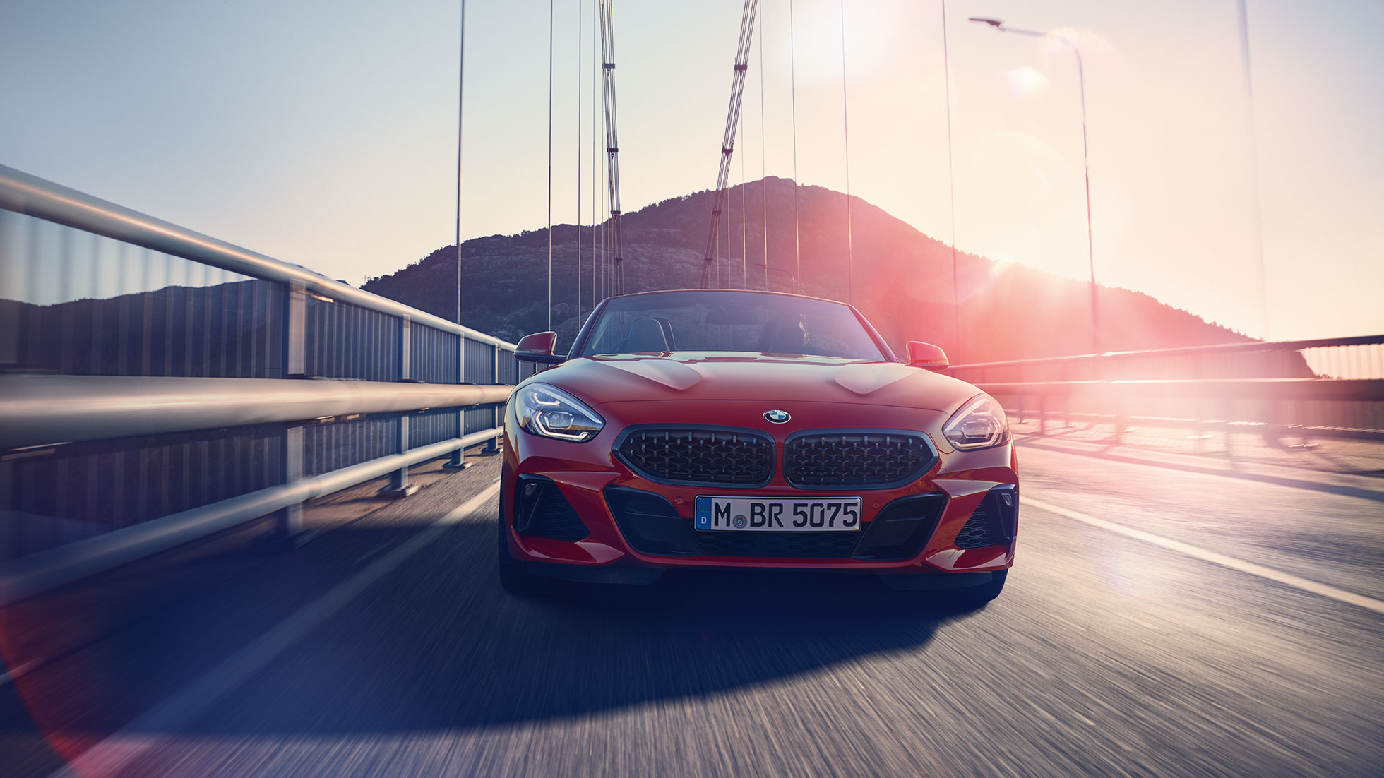 BMW Z4 Roadster op een brug Vooraanzicht van de BMW Z4 Roadster op een brug