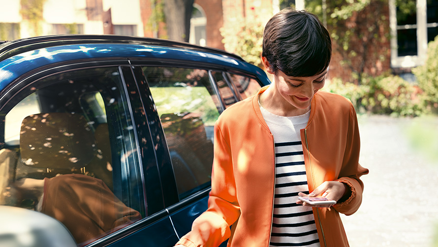 BMW Accessoires zomer BMW Teleservices BMW Accessoires zomer BMW Teleservices met vrouw voor BMW en smartphone