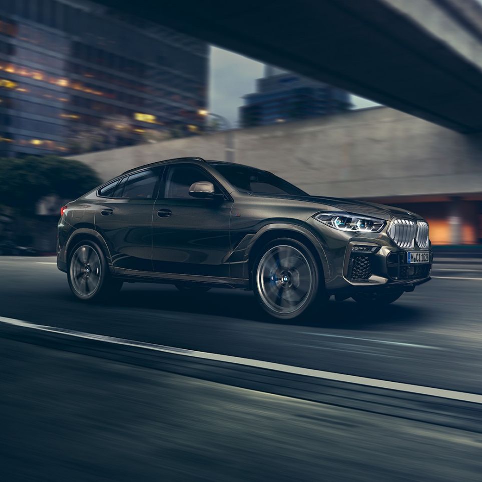 BMW X6 rijdend BMW X6 in driekwart vooraanzicht rijdend in een stedelijke omgeving